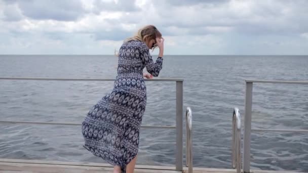 Cute female in sunglasses on background of seafront, smiling girl Resting on seafront, Relaxing holiday of young woman — Wideo stockowe