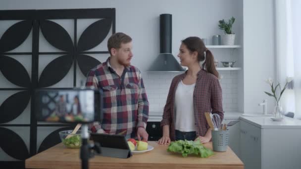 Blog de alimentación saludable, bloggers mujeres y hombres preparan alimentos útiles con verduras y verduras en la cocina, mientras que la cámara de teléfono móvil graba video para seguidores en las redes sociales — Vídeos de Stock