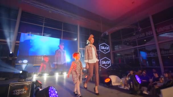 Stijlvolle Catwalk model met kind meisje gaan op het podium op presentatie show van designer kleding op mode-avond — Stockvideo
