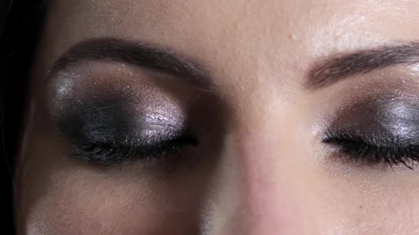 Bright make-up on eyes of young woman, passionate look — 图库视频影像
