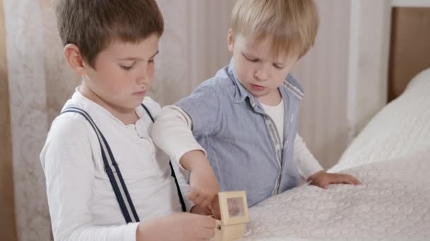 Infancia, guapos pequeños machos se divierten juntos juego de caja de melodía — Vídeos de Stock