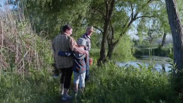 Семейные отношения, любящая заботливая счастливая бабушка обнимается со своим любимым радостным внуком во время совместной прогулки под открытым небом — стоковое видео