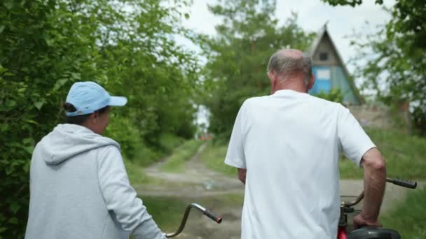 Livsstil, äldre man och kvinna i pensionsåldern är söta prata och tala när du återvänder från en cykeltur — Stockvideo