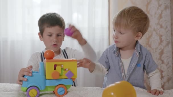 Gry domowe, małe słodkie dzieci dobrze się bawią rozwijając swoje kreatywne myślenie podczas zabawy z dziećmi kolorowe zabawki w pokoju — Wideo stockowe