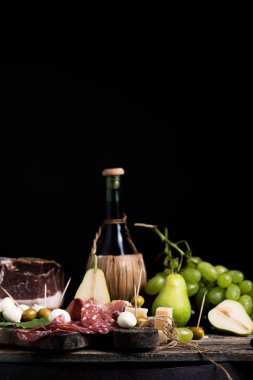 Rustik geleneksel İtalyan yemekleri ile bir tabloda şarap şişesi. Taze tipik İtalyan yaşam tarzı
