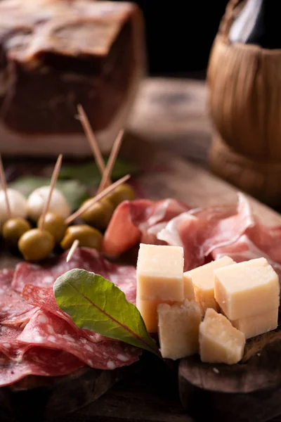 Italian antipasti on wooden table, close up