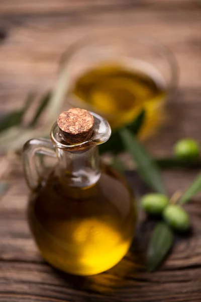 橄榄油在一个瓶子上的木材背景 — 图库照片