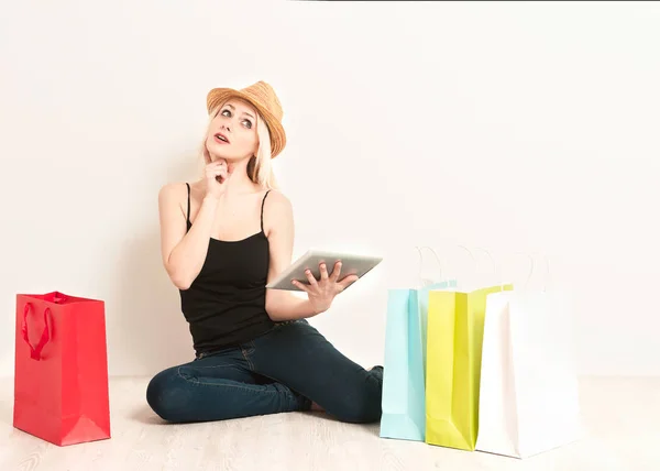 Lady at home with shopping bag and tablet. Shopping on line concept