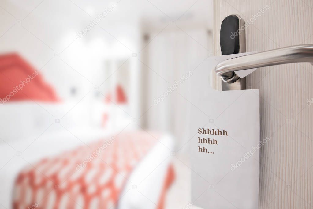 The hotel room with DO NOT DISTURB sign on the door 