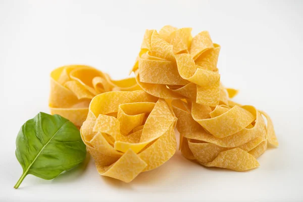 Raw pasta on white surface — Stock Photo, Image