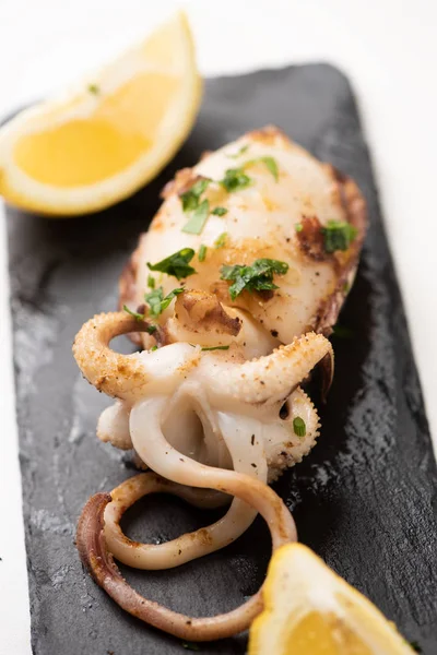 Delicioso pescado barbacoa cuttle en un plato de piedra —  Fotos de Stock