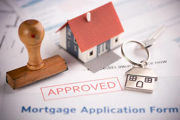 An approved Mortgage loan application form with house key and r