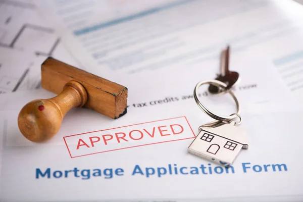 An approved Mortgage loan application form with house key and r