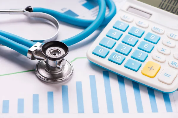 Medical practice financial analysis charts with stethoscope and