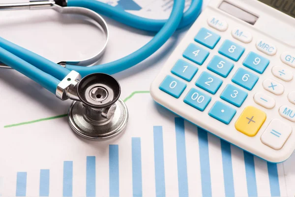 Medical practice financial analysis charts with stethoscope and