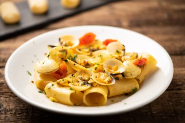 Beyaz plaka üzerinde istiridye ile Paccheri makarna