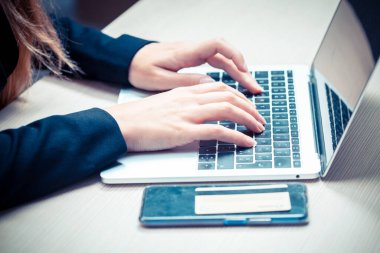 Çevrimiçi ödeme, kredi kartı tutan kadınların elleri ve çevrimiçi alışveriş için akıllı telefon kullanımı.