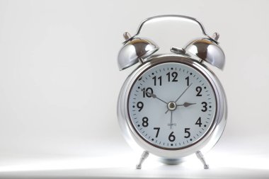Nice old vintage chrome metal twin bell alarm clock on white background.	