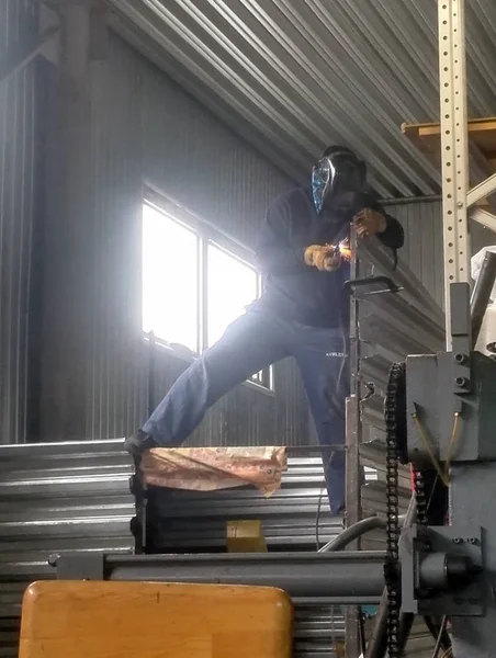 welder working at height in production hall