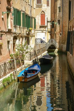 Adam oturan ve birçok nar biri üzerinde küçük bir köprü üzerinde okuma