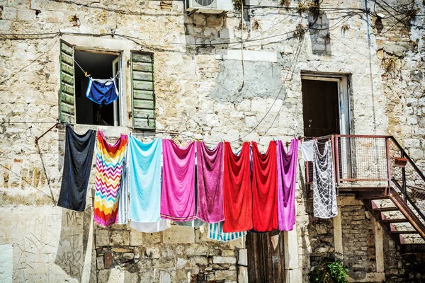Drying clothes in front of the old house. Mediterranean architecture.
