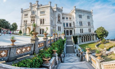 MIRAMARE CASTLE, ITALY - AUGUST 8, 2018 Miramare castle near Trieste, northeastern Italy. Travel destination. Panoramic photo. Illustrative editorial. clipart