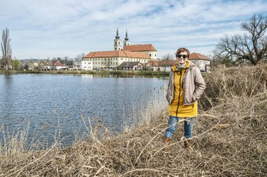 Tourist woman with Basilica minor in Sastin-Straze, Slovakia clipart
