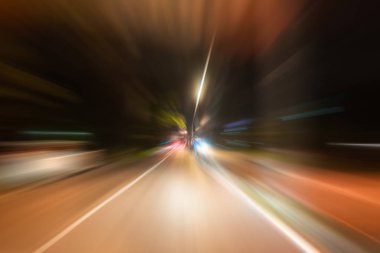 Gece trafik fütüristik hareket ile bulanıklık ve yakınlaştırma efektleri. Üzerinden yol veya sokaklar üzerinde hareket eden bir arabanın içinde ateş.