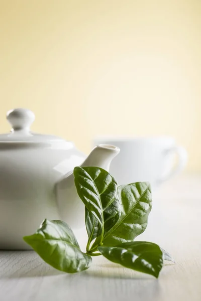 Teeblätter Auf Dem Tisch Mit Teekanne Und Tasse — Stockfoto