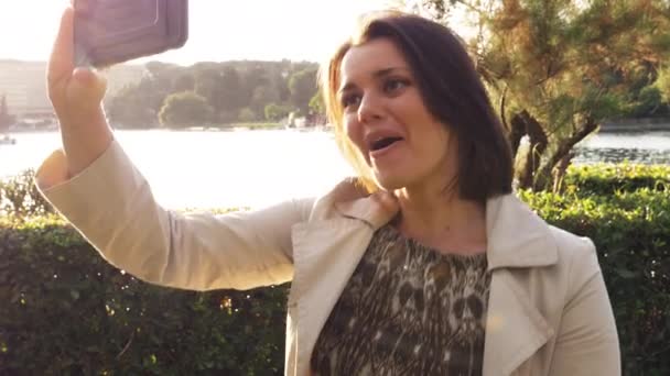 在欧洲城市度假的公园里 从湖边打视频电话的快乐女人 — 图库视频影像
