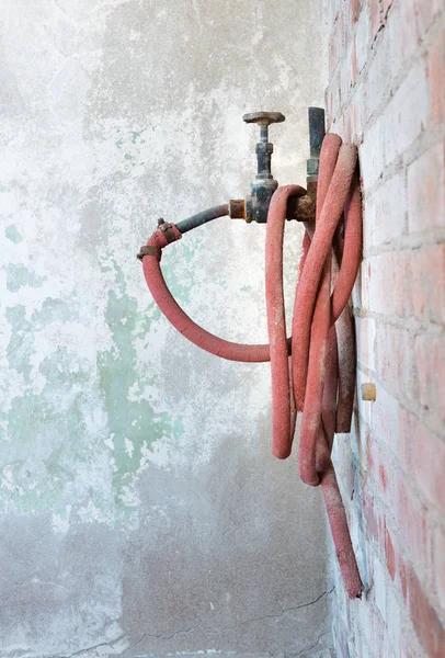 Old Retro Water Crane Coil Red Rubber Hose Stock Picture