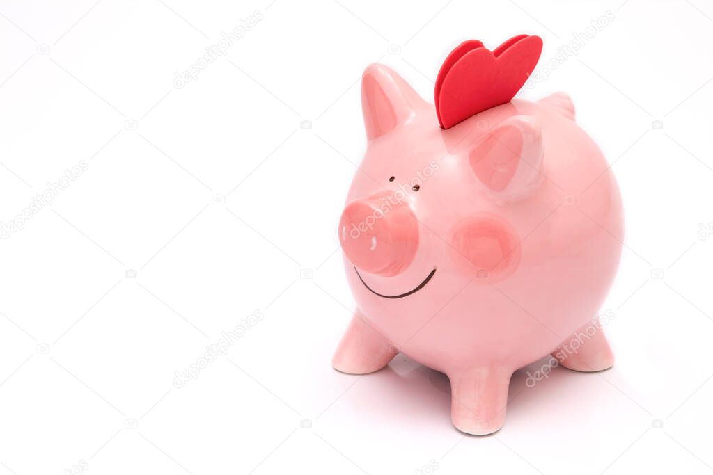 Two red hearts on a piggy bank. Depositing love and happiness concept.