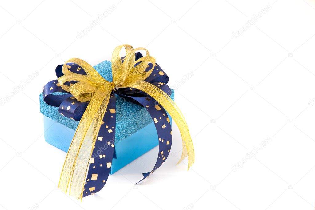 A beautiful blue gift box with blue and gold ribbons on white background. A present for Holidays, Christmas, New Year, Valentine's, Birthday, Anniversary concept.
