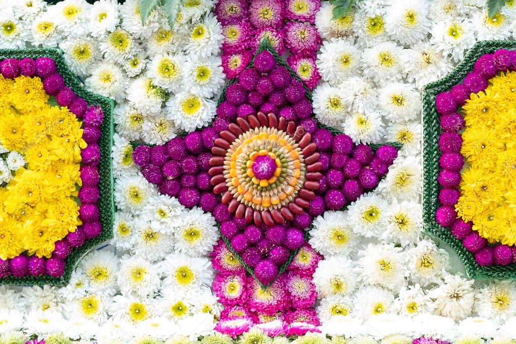 Closeup details of intricate patterns of flowers and seeds on floats used in the February Flower Festival Parades in the City of Chiangmai, Thailand. The beautiful central mandala is made of red and green beans, corns, and rice.  