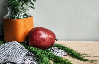 Sağlıklı temalı detoks Taze kırmızı armut, el yapımı kumaş ve yeşil yapraklı mason kavanozu