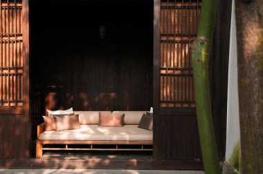 18 AUG, Hangzhou, Çin: Eski Çin evindeki eski ahşap sürgülü kapıların arkasındaki modern Çin tarzı kanepe