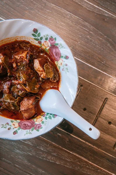 餐桌上的泰国菜 猪肚咖哩 用老式碗盛着勺子和木桌上方的景色拍摄 — 图库照片