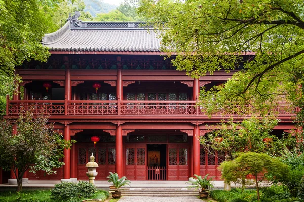 AUG 17, 2011 Hangzhou, China : Red grand wooden prayer hall of Lingyin temple among big tree, sacred place for monks use for praying and other religion activity.