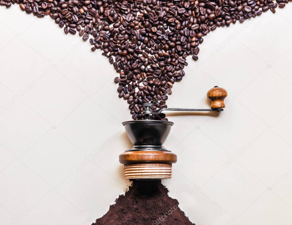 Roasted black Coffee beans dropping into retro wooden grinder and come out ground coffee at image center islotaed on white background copy space for commercial design work