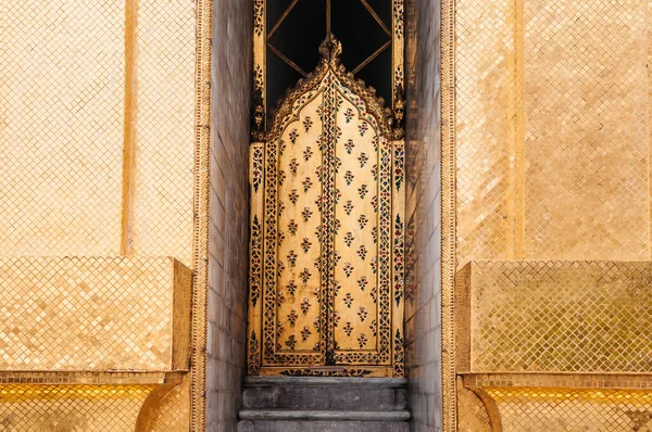 Beautiful elegant Artisan golden mosaic tiles wall and gate of Pagoda Bangkok Grand Palace - Wat Phra Kaew - Emerald Buddha Temple