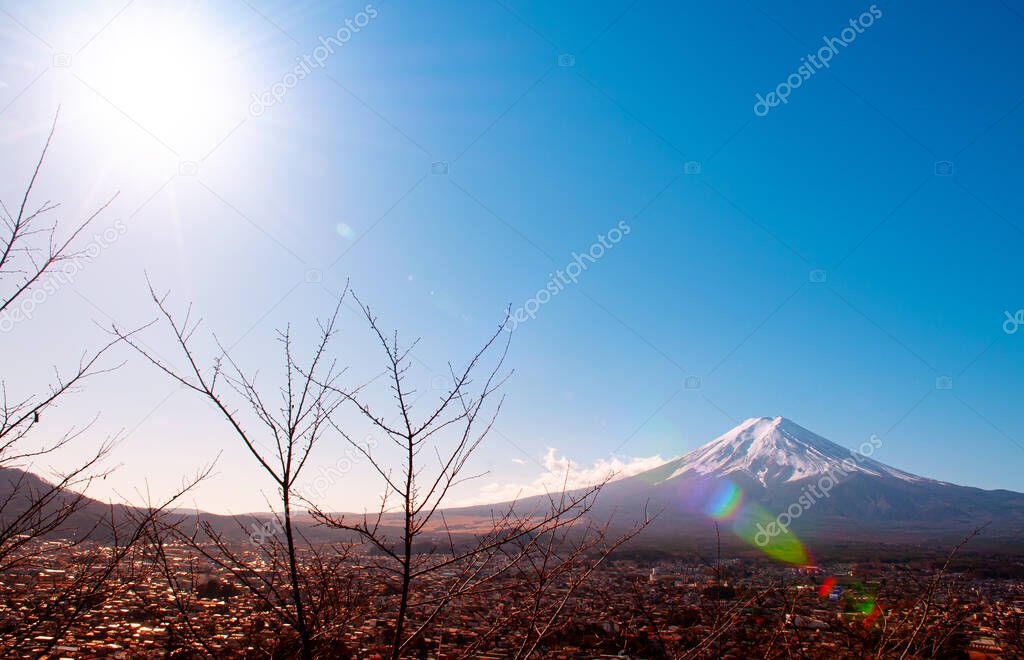 Mount Fuji with snow and blue sky sun flare, colourful autumn tree with Shimoyoshida city seen from Chureito Pagoda Arakurayama Sengen Park in Fujiyoshida near Kawaguchigo