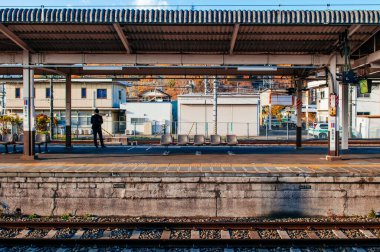 NOV 30, 2018 Otsuki, Japonya - sıcak güneş ışığı altında sessiz Otsuki istasyonunda Japon yolcu. JR ve Fujikyu arasındaki kavşak istasyonu - Fuji Tozan Densha hattı.