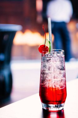 Taze buz gibi soğuk, kiraz kokteyle buz küpleri masasında berrak bardakta.