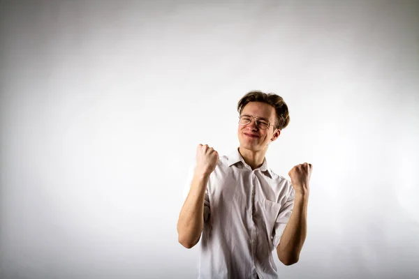 Young man in white is rejoicing. — Stock Photo, Image