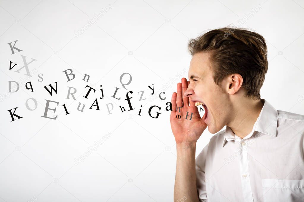 Young man is screaming. Screaming and letters concept.