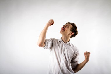 Young man in white is rejoicing. clipart