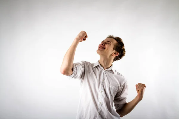 Young man in white is rejoicing. — Stock Photo, Image