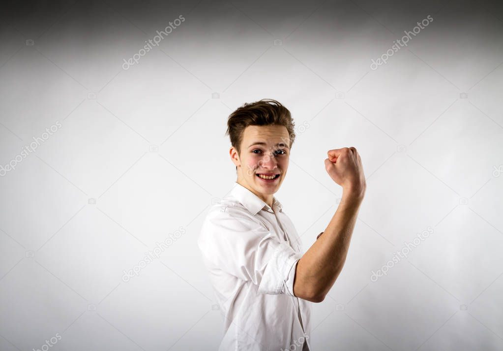 Young man in white is rejoicing.