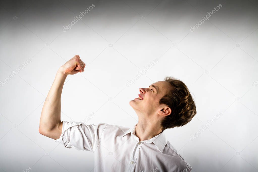 Young man in white is rejoicing.