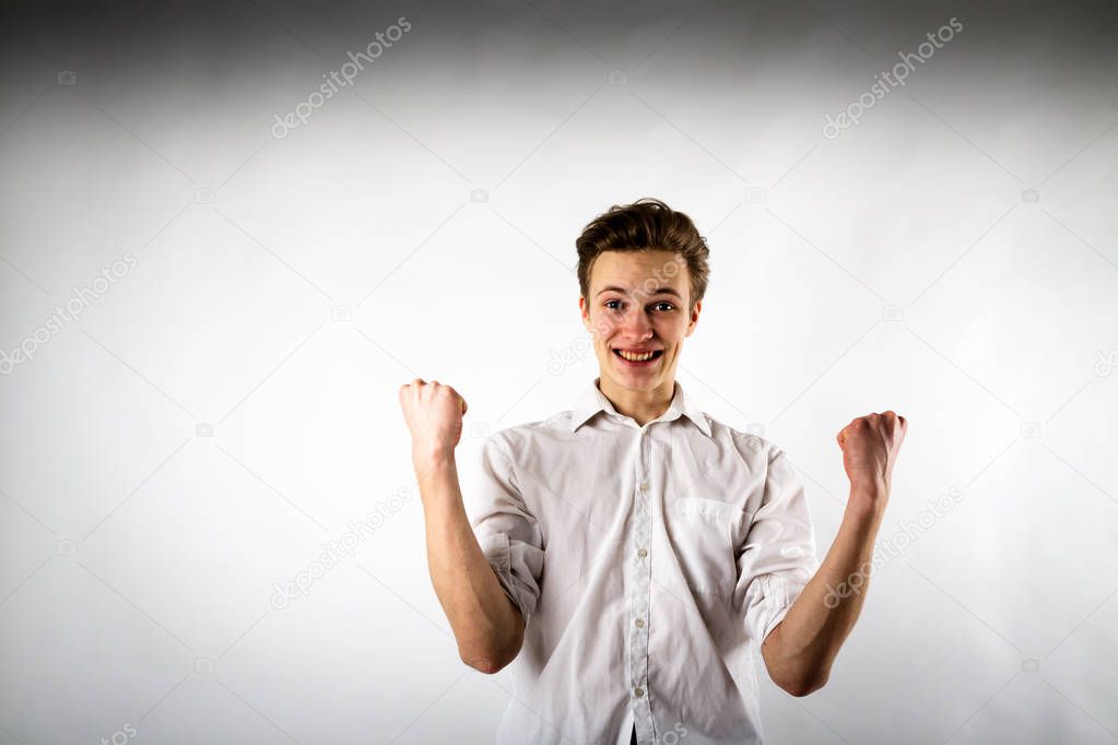 Young man in white is rejoicing.